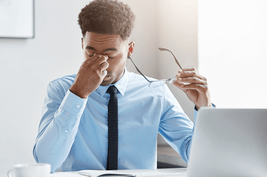 Man Tired at Work Due to Loss of Quality Sleep
